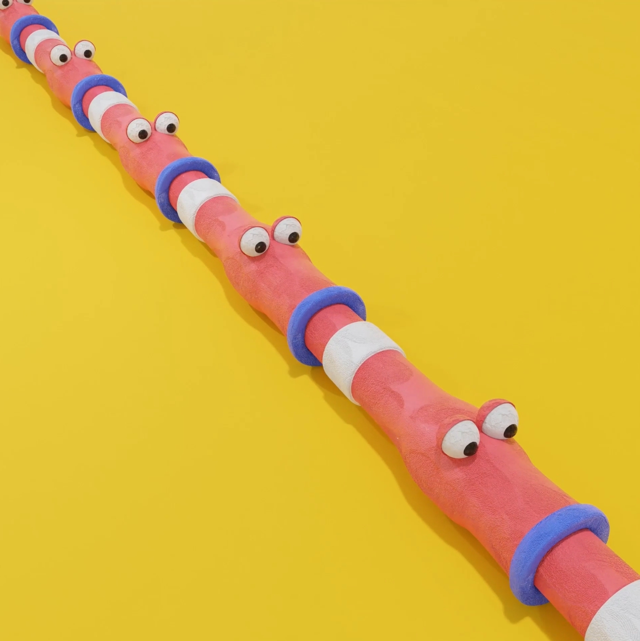 A row of worms eating each other in claymation style